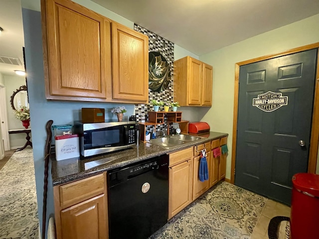 kitchen featuring backsplash, black dishwasher, sink, and light tile patterned floors