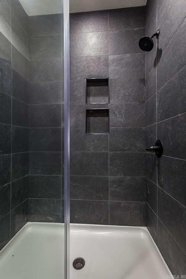 bathroom with a tile shower