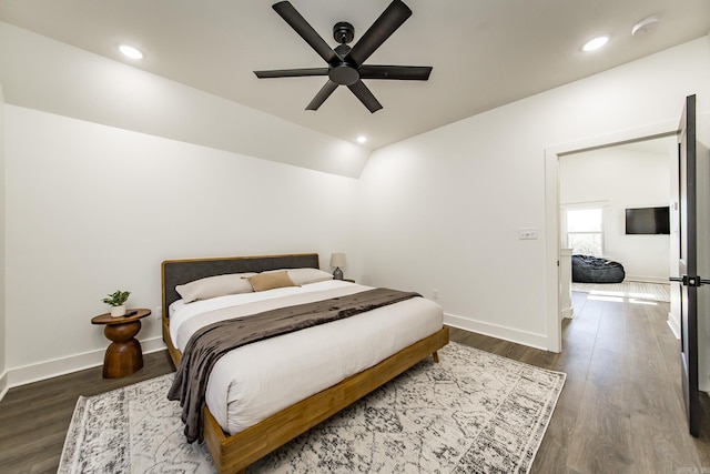 bedroom with dark wood-type flooring, ceiling fan, and vaulted ceiling