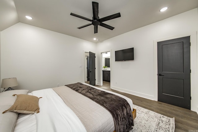 bedroom with ceiling fan, lofted ceiling, dark hardwood / wood-style flooring, and ensuite bathroom