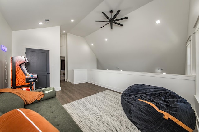 living area featuring vaulted ceiling, dark wood-type flooring, and ceiling fan