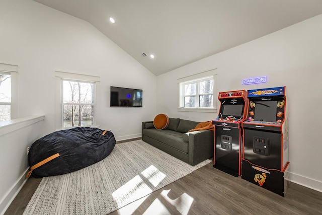 living room with dark wood-type flooring and high vaulted ceiling