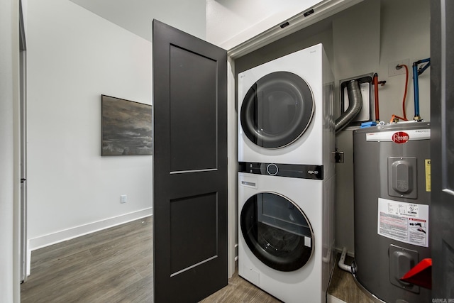 washroom with hardwood / wood-style flooring, water heater, and stacked washer / dryer