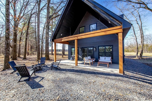 view of community featuring a patio and a fire pit