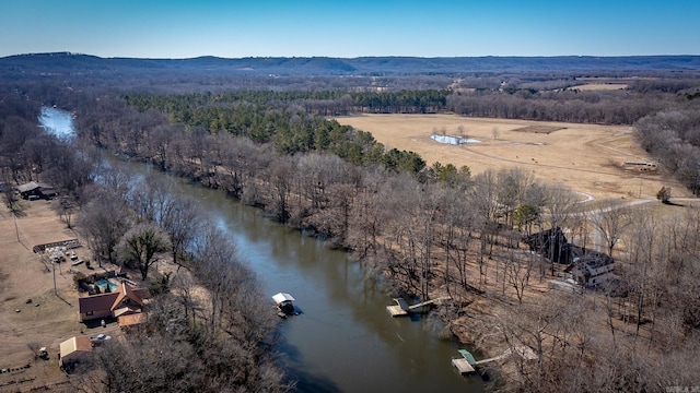 birds eye view of property with a water and mountain view