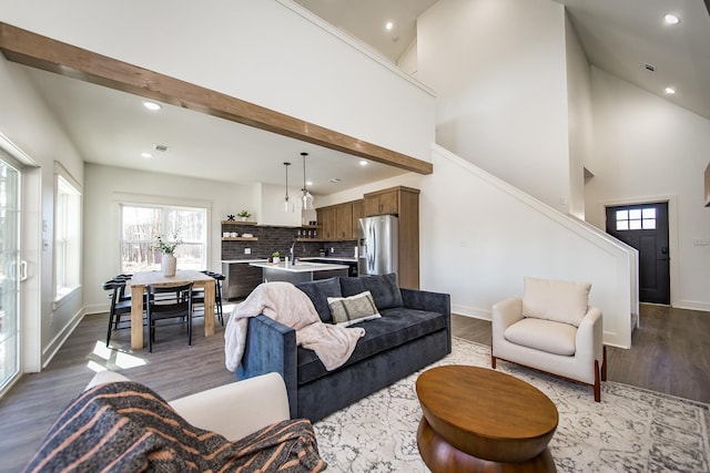 living room with hardwood / wood-style flooring and a towering ceiling