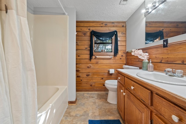 full bathroom featuring shower / tub combo, wooden walls, vanity, a textured ceiling, and toilet