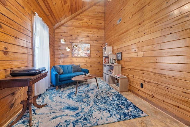 sitting room with lofted ceiling, wooden walls, and wooden ceiling