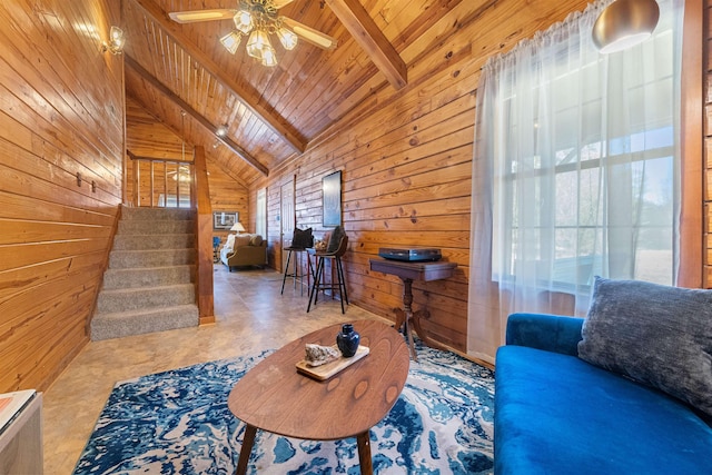 living room with wood ceiling, wooden walls, lofted ceiling with beams, and ceiling fan