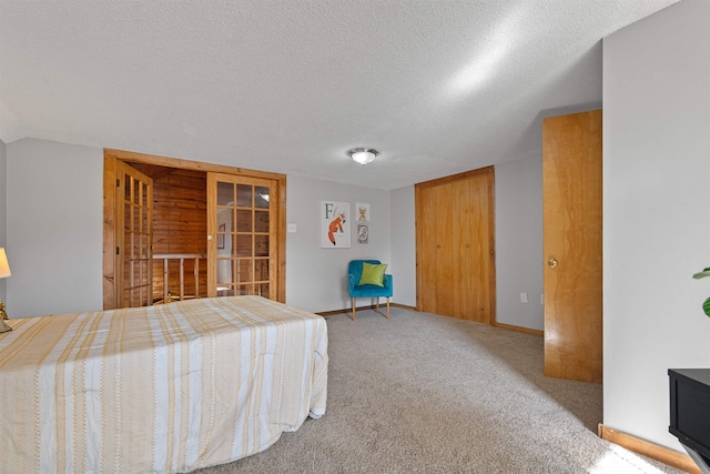 carpeted bedroom with a closet and a textured ceiling