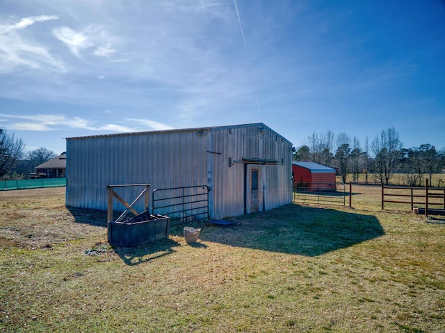 view of outdoor structure featuring a yard and a rural view