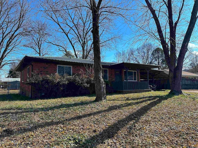 single story home with covered porch and a front lawn