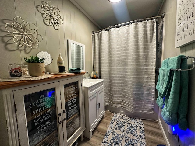 bathroom with vanity, crown molding, wood-type flooring, and a shower with shower curtain