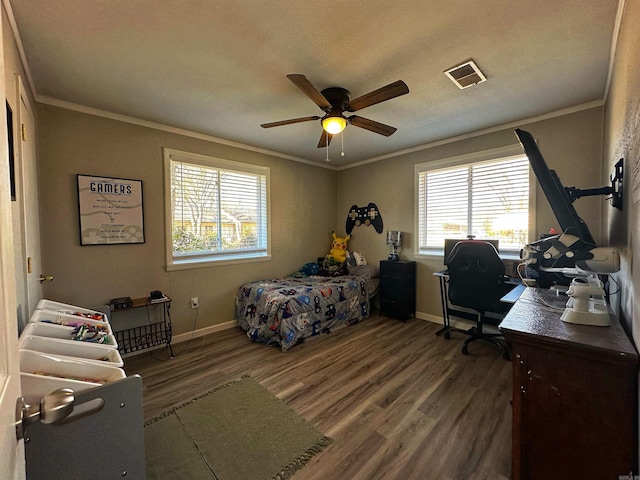 bedroom with wood-type flooring, ornamental molding, and ceiling fan