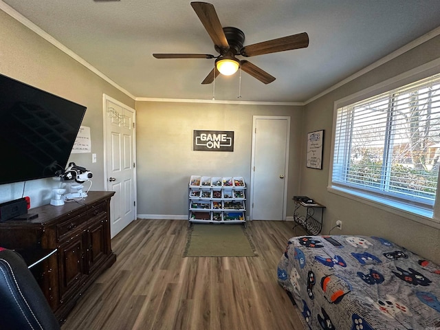 bedroom with crown molding, ceiling fan, and light hardwood / wood-style flooring