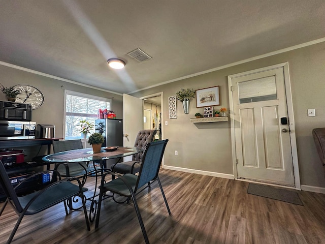 dining room featuring crown molding and dark hardwood / wood-style flooring