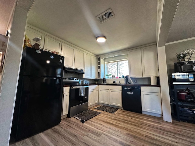 kitchen with white cabinetry, crown molding, light hardwood / wood-style floors, and black appliances