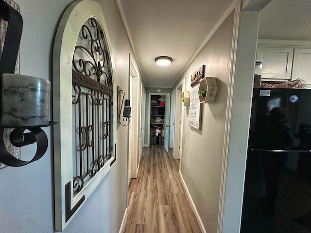 corridor with light hardwood / wood-style flooring