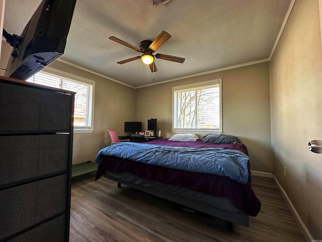 bedroom featuring ornamental molding, wood-type flooring, and ceiling fan