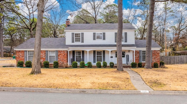 view of front of home with a porch and a front lawn