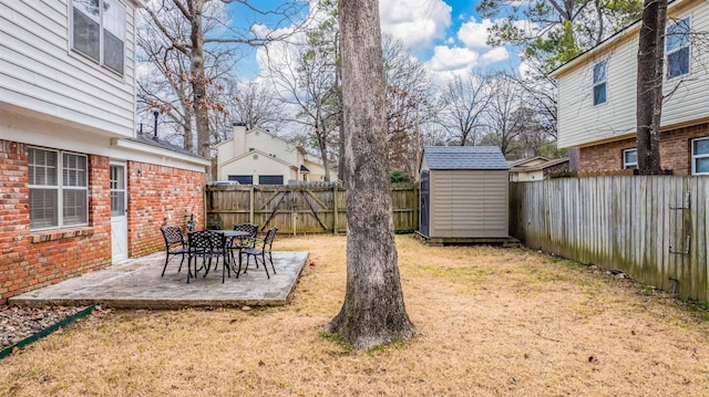 view of yard featuring a storage unit and a patio