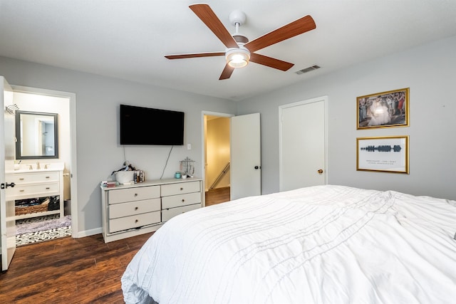 bedroom featuring ensuite bathroom, dark hardwood / wood-style floors, and ceiling fan