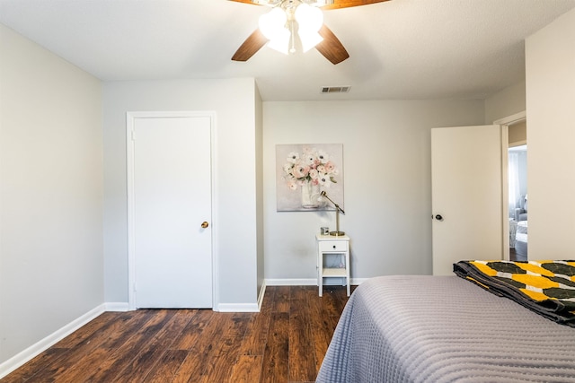 bedroom with ceiling fan and dark hardwood / wood-style flooring