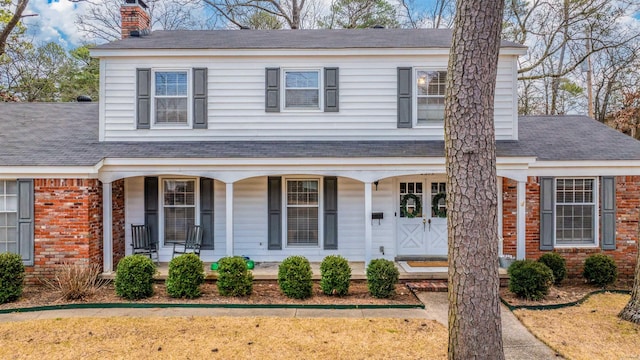 view of front of house featuring a front yard and a porch