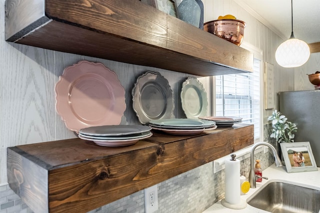 room details with pendant lighting, sink, and ornamental molding