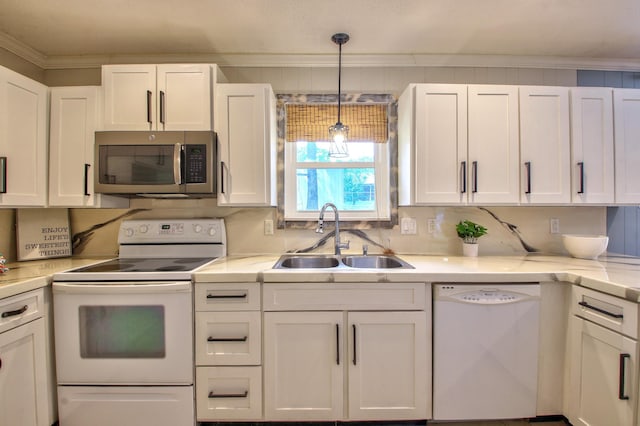 kitchen with white appliances, sink, white cabinets, and ornamental molding