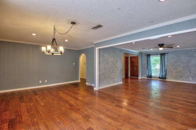 spare room with ornamental molding, wood-type flooring, and a textured ceiling