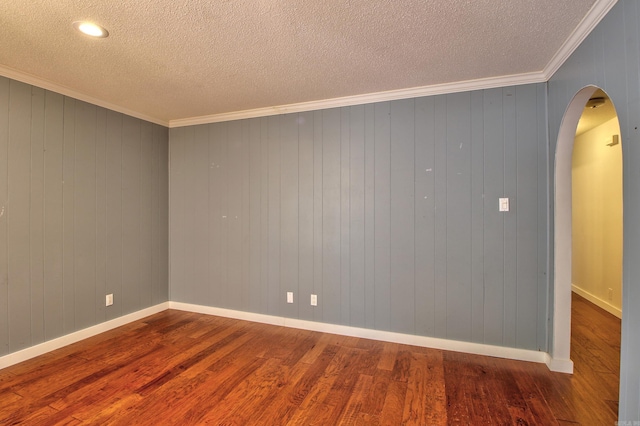 unfurnished room featuring hardwood / wood-style floors, a textured ceiling, and ornamental molding