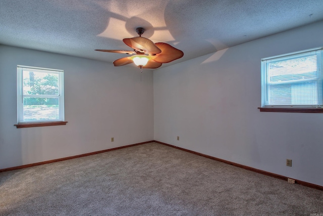 empty room with carpet, ceiling fan, and a textured ceiling