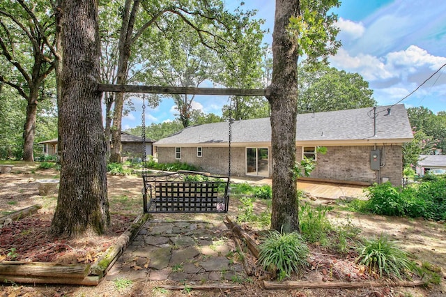 back of house with a deck