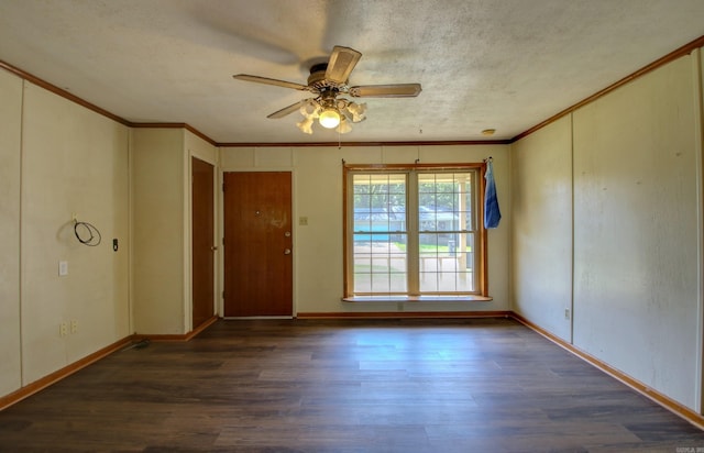 spare room featuring dark hardwood / wood-style flooring, ceiling fan, ornamental molding, and a textured ceiling