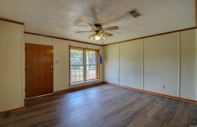 spare room with ornamental molding, dark wood-type flooring, ceiling fan, and a textured ceiling