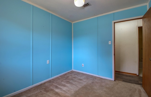 carpeted spare room with crown molding