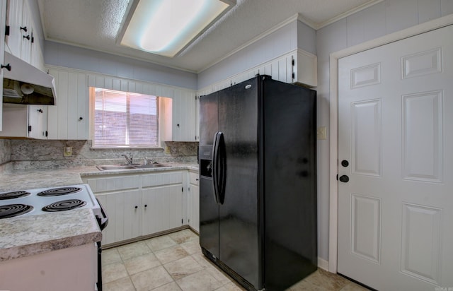 kitchen featuring black fridge, white cabinetry, crown molding, and sink