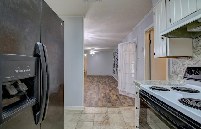 kitchen with ceiling fan, ornamental molding, black appliances, a textured ceiling, and white cabinets