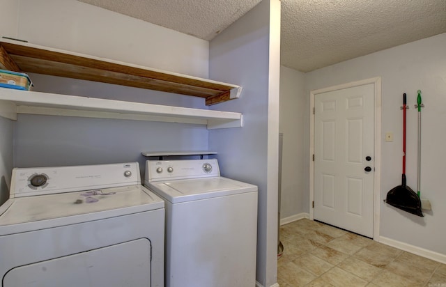 washroom with separate washer and dryer and a textured ceiling