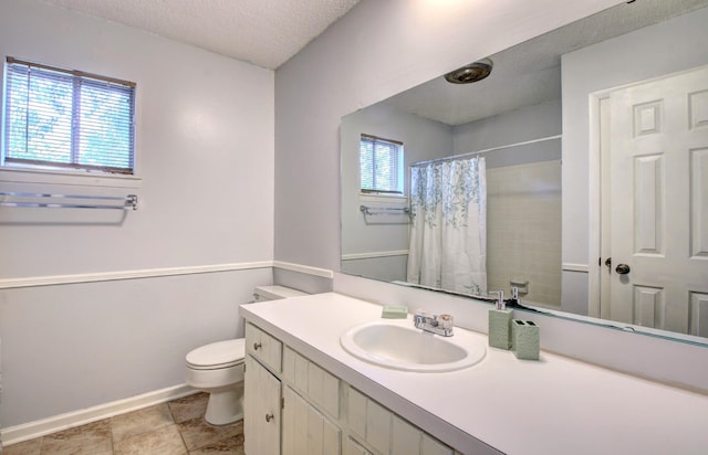 bathroom featuring vanity, curtained shower, toilet, and a textured ceiling