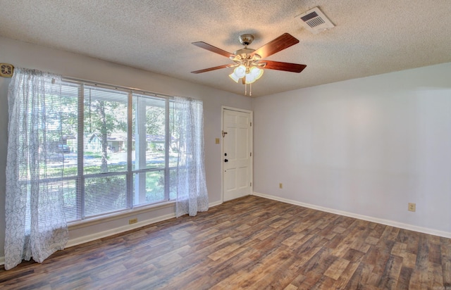 spare room with ceiling fan, dark hardwood / wood-style flooring, and a textured ceiling