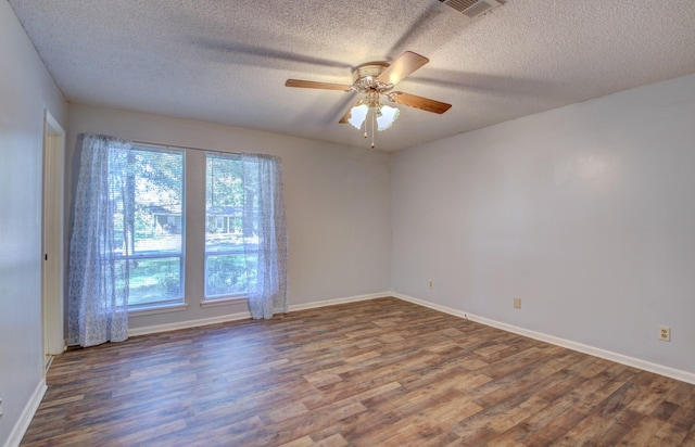 spare room featuring hardwood / wood-style flooring, ceiling fan, and a textured ceiling