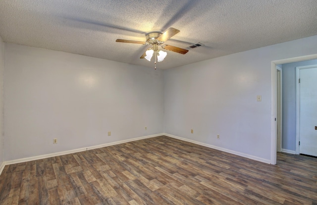 spare room featuring ceiling fan, dark wood-type flooring, and a textured ceiling