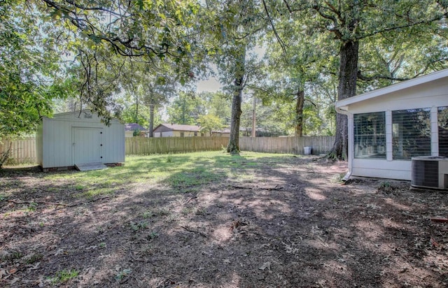 view of yard featuring cooling unit and a storage unit