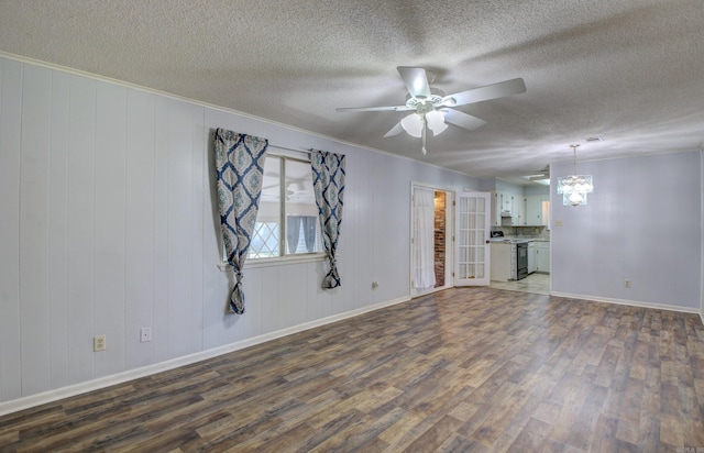 unfurnished living room featuring crown molding, ceiling fan with notable chandelier, wood-type flooring, and a textured ceiling