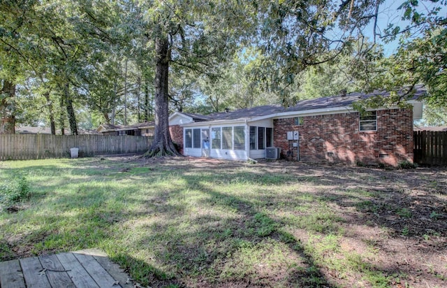 view of yard with cooling unit and a sunroom