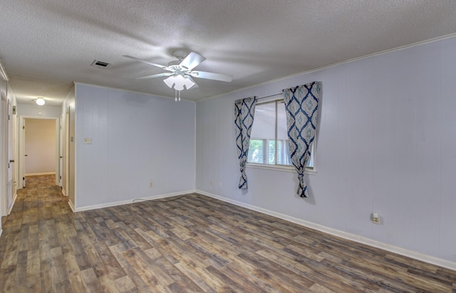 unfurnished room with crown molding, dark hardwood / wood-style floors, a textured ceiling, and ceiling fan