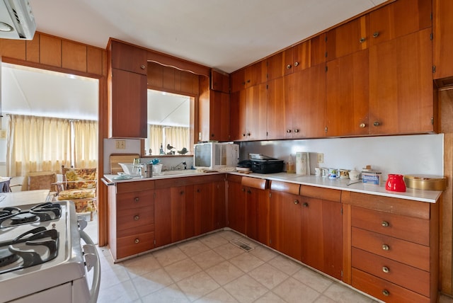 kitchen featuring sink and white gas range oven