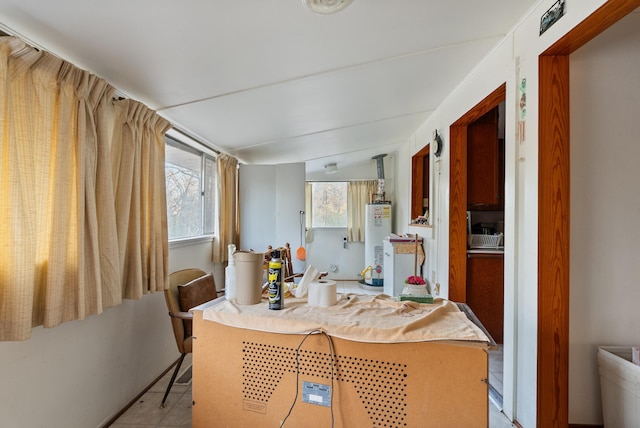 kitchen featuring gas water heater and a breakfast bar